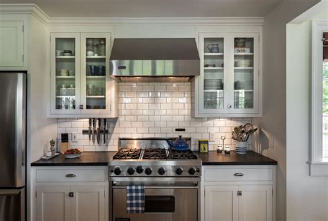 White kitchen cabinets - Stainless steel appliances - Subway tiles ...