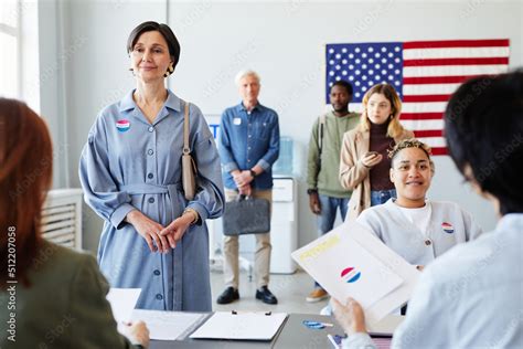 Front view portrait of diverse people standing in line on voting day in election office Stock ...