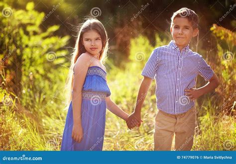 Beautiful Little Boy and Girl Holding Hands at the Park. Stock Photo - Image of person, child ...