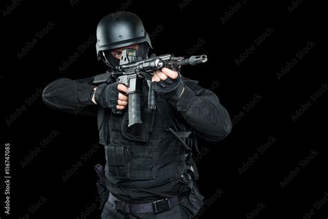 Spec ops police officer SWAT in black uniform and face mask Stock Photo | Adobe Stock