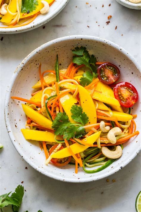 Spicy Thai Mango Salad is full of fresh flavors including mango, cucumber, carrots, tomato, cil ...