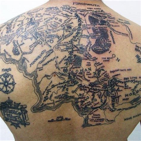 a map tattoo on the back of a man's upper body is shown in black ink