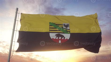 Saxony-Anhalt flag, Germany, waving in the wind, sky and sun background ...