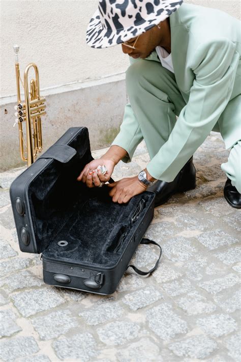 Man Removing the Money in His Guitar Case · Free Stock Photo