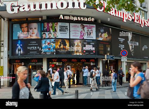 Paris, France, Front French Cinema Theatre, cinema posters, Crowd people walking on the champs ...