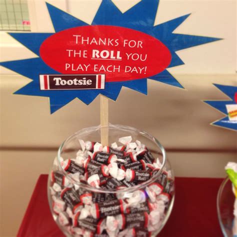 a bowl filled with lots of candy sitting on top of a red table next to a sign that says, thanks ...