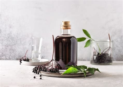 Premium Photo | Delicious black elderberry liqueur in a glass bottle