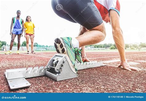 Runner Using Starting Block To Start His Run on Race Track - Young ...