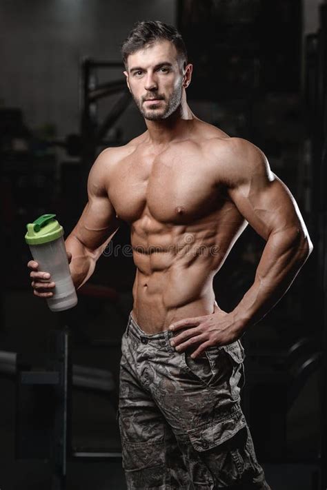 Handsome Athletic Fitness Man Holding a Shaker and Posing Gym Stock Photo - Image of fitness ...