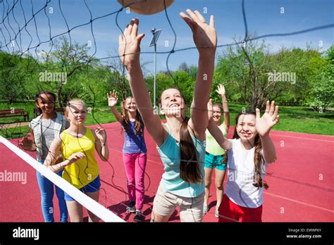 Teenagers team playing volleyball on the court Stock Photo - Alamy