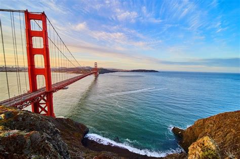 Premium Photo | Iconic Golden Gate Bridge next to ocean beach waves ...