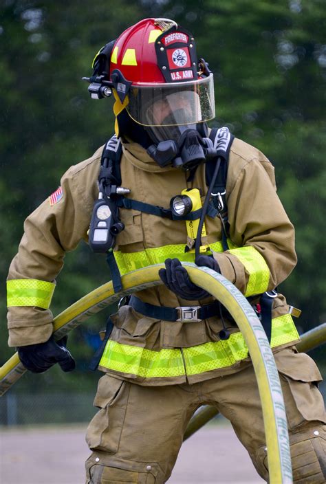 Nebraska Army National Guard Sgt. Marco Flores holds a fire hose during an aircraft rescue and ...