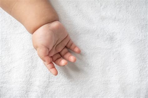 Free Photo | Newborn baby hand in white bed