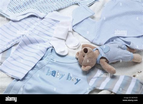 Baby boy clothes with teddy bear Stock Photo - Alamy