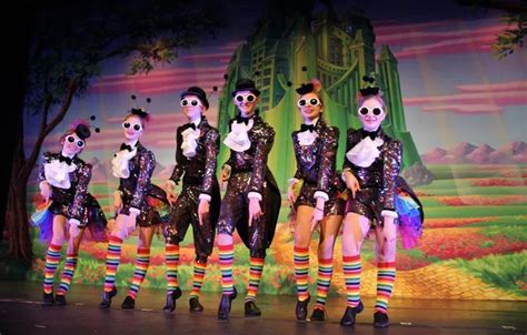 a group of people standing on top of a stage wearing skeleton makeup and colorful socks