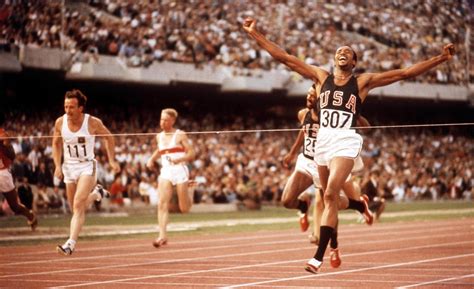 US athlete Tommie Smith (#307) crosses the finish line in first place ...