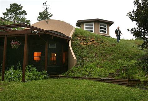 Earth home Down a dirt road and between thickets of trees, Paul Queen ...