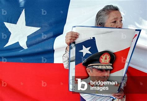 Image of A supporter of former leader Gen. Augusto Pinochet holds a