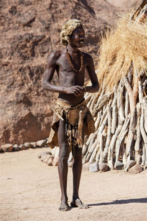 A young man in traditional Damara People clothes is posing at The Living Museum of the Damara ...