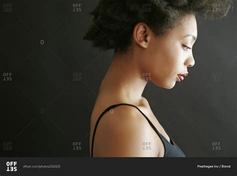 Close up profile of woman looking down stock photo - OFFSET