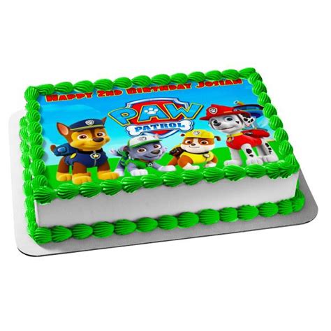 a birthday cake with paw patrol characters on the top and green ...