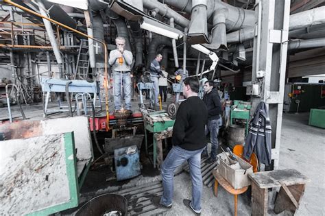 Premium Photo | Glass production worker working with industry equipment on factory