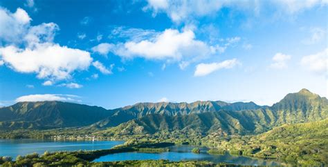 Green Forested Mountain Range Under Blue Sky With Clouds · Free Stock Photo