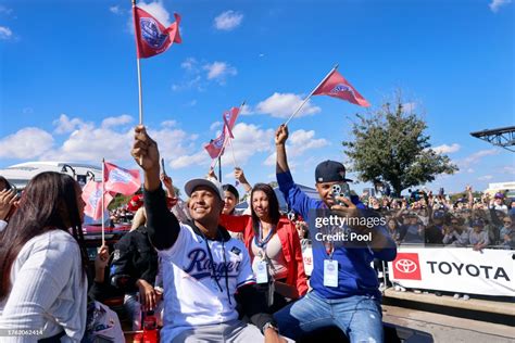 Jose Leclerc of the Texas Rangers and his family wave flags as they ...