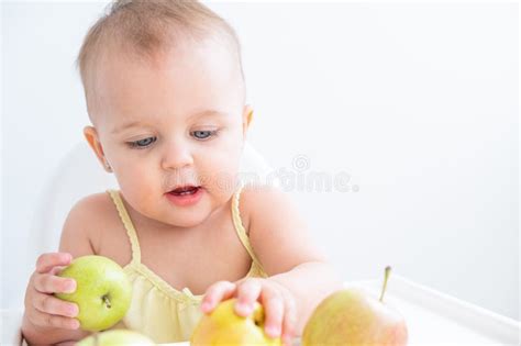 Cute Baby Girl in Baby Chair Eating Apples. Baby First Solid Food Stock Image - Image of food ...