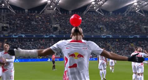 Chelsea target Christopher Nkunku pulls balloon out of sock in Champions League celebration ...