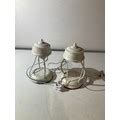 A pair of white metal lantern style table lamps