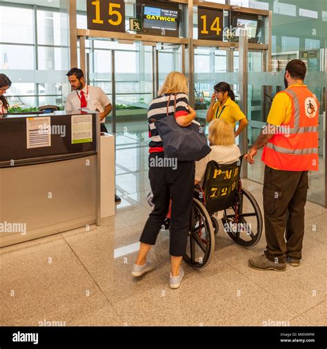 A disabled passenger in a departure lounge at the airport in Mahon , Menorca , Balearic Islands ...