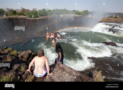 People swimming in Devils Pool at the edge of the Victoria Falls Stock Photo: 62087424 - Alamy