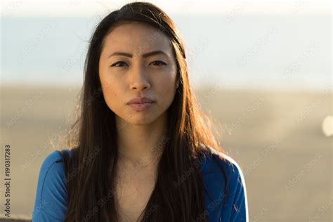 Young Asian woman serious face Stock Photo | Adobe Stock