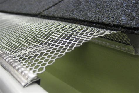 Mesh gutter guards are sheets filled with holes that cover the gutter ...