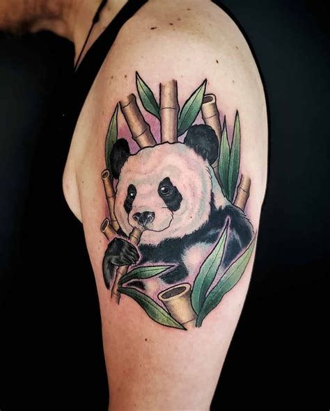 a panda bear with bamboo sticks and leaves on it's back half - sleeve