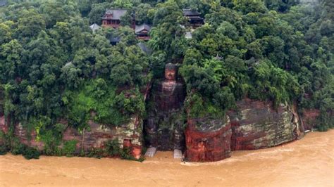 Flood waters reach the toes of China’s famous giant Buddha statue | CNN