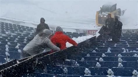 Buffalo Bills fans make snow slide while shoveling stadium