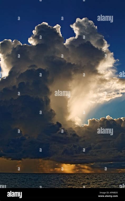 Storm clouds at sunset over ocean Stock Photo - Alamy