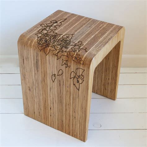 a wooden stool with flowers painted on the side and two hearts drawn on ...