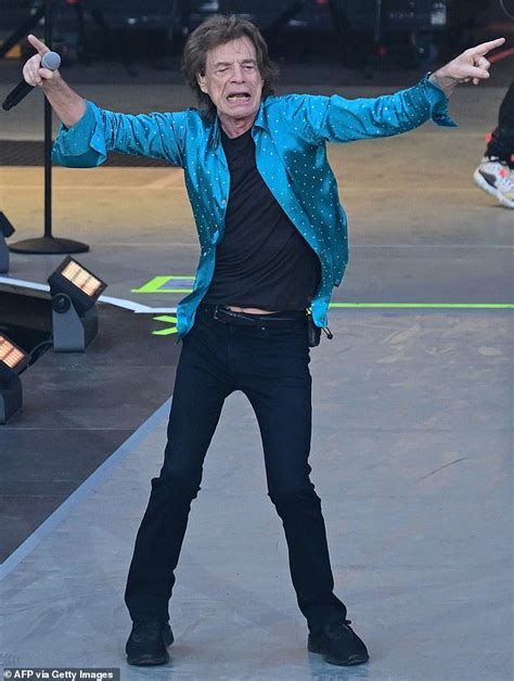 Mick Jagger puts on an animated display as he dances across stage at ...