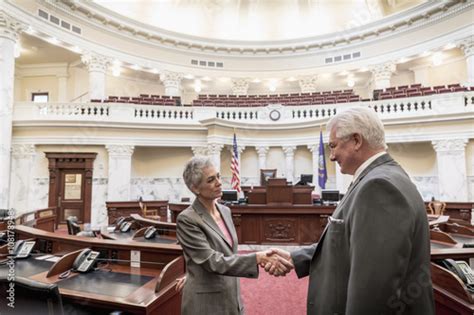 "Caucasian politicians shaking hands in capitol building" Stockfotos ...