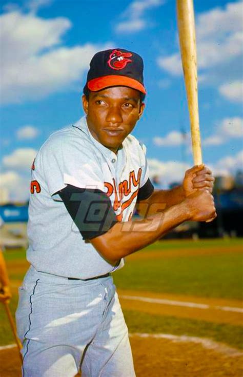 a man holding a baseball bat on top of a field