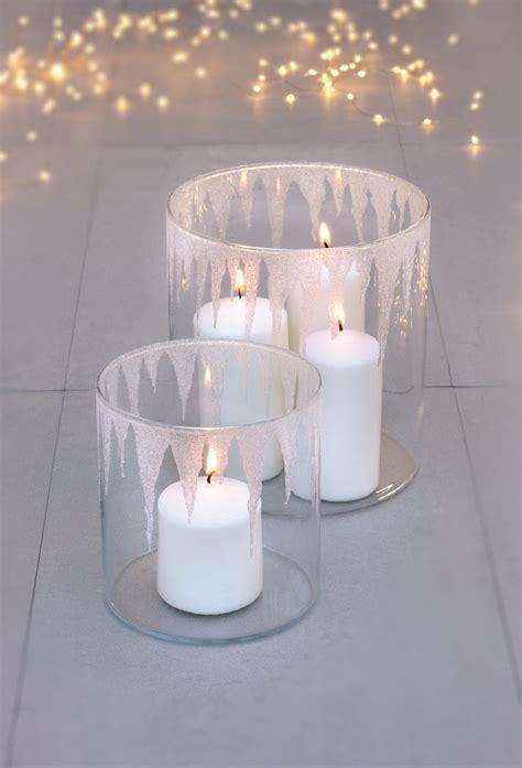 three clear glass candles are on the ground