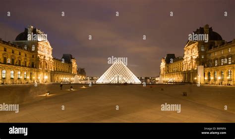 The Louvre Museum illuminated glass pyramid entrance Paris France Stock ...