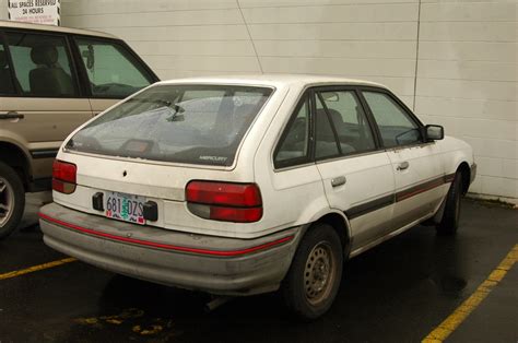 OLD PARKED CARS.: 1988 Mercury Tracer 5-Door Hatchback.