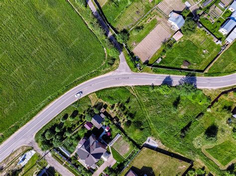 Premium Photo | Aerial top drone view of the road, houses and fields