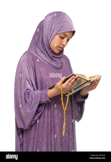 Beautiful Arab Muslim Girl in Islamic Fashion Dress Reading Holy Book of Quran With Happy Smily ...