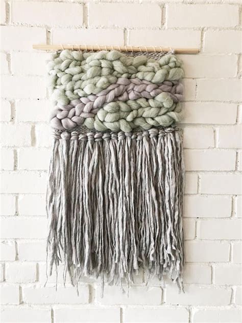 This woven wall hanging is made with beautiful wool fibre. Mounted on wooden dowel for a clean ...