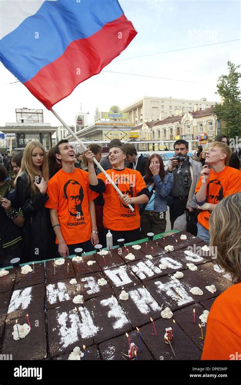 Members of `Putin` fan club marking Vladimir Putin`s 54th birthday with a big fancy cake and ...